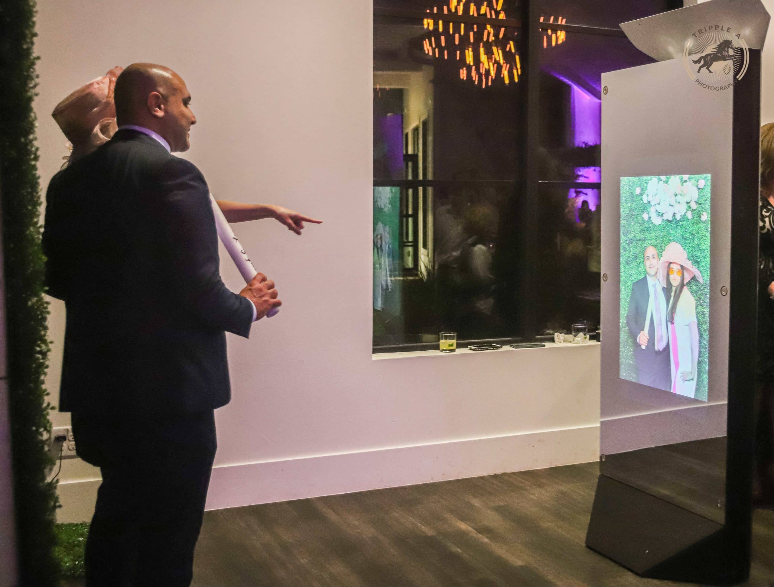Guest interacting with the Mirror X photo booth at an event